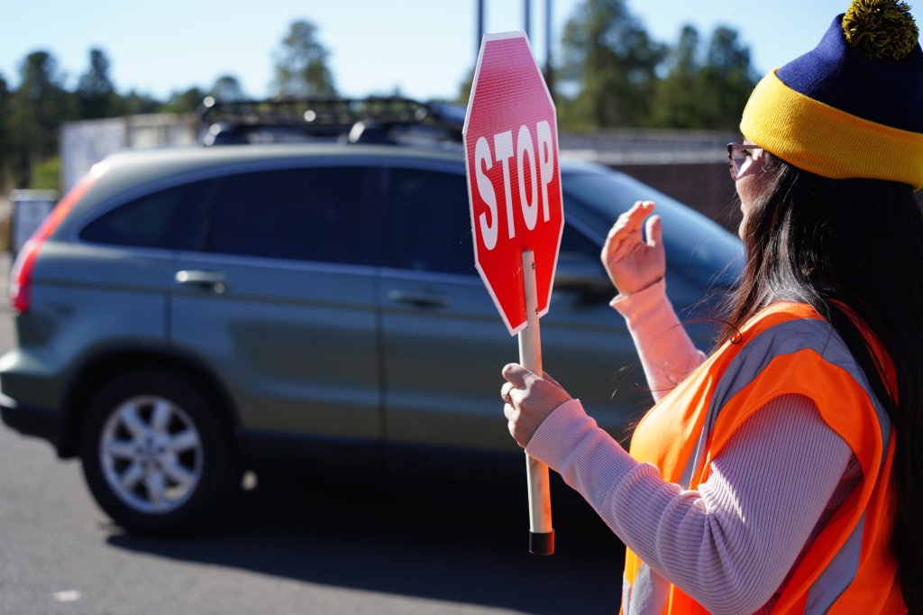 Workers direct traffic at a food center distribution site.
